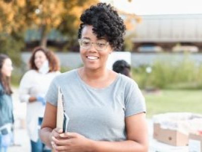 Woman holding clipboard outside